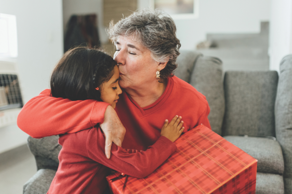Family Christmas Morning grandmother hugs grandaughter