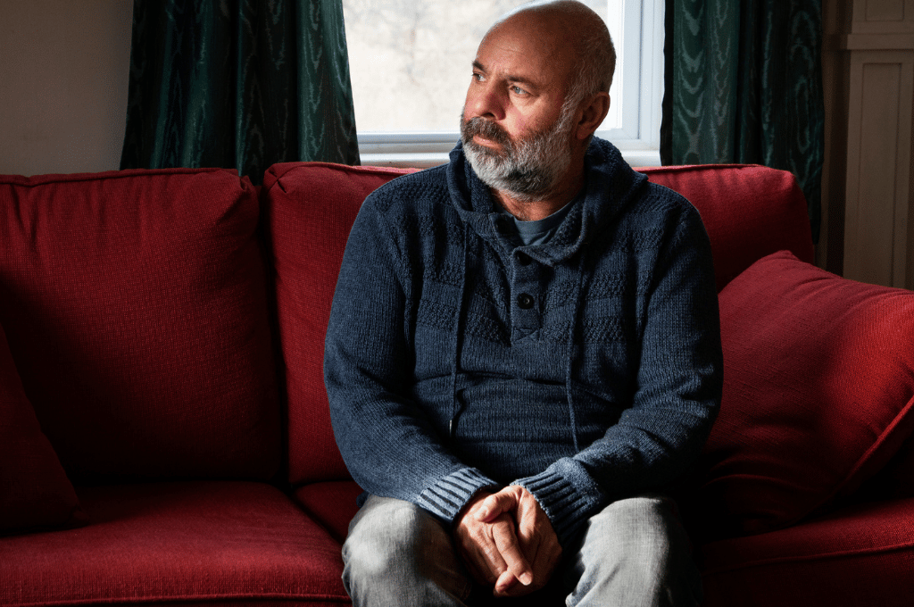 Man on couch looking outside