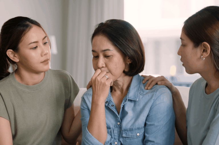 Daughters embracing mother
