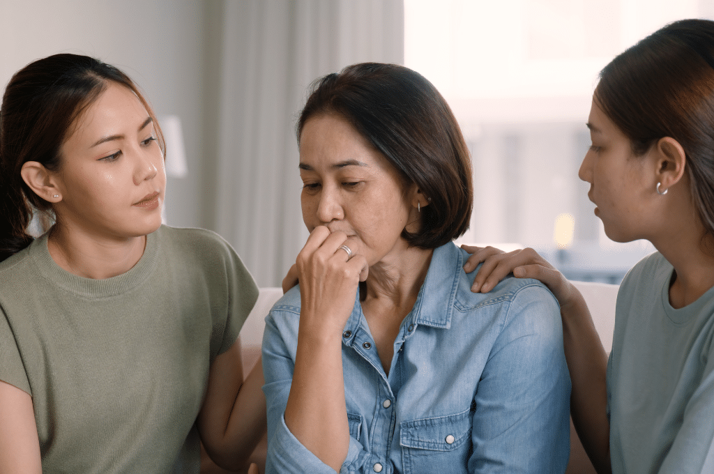 Daughters embracing mother