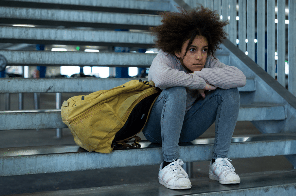 Sad teenager on stairs