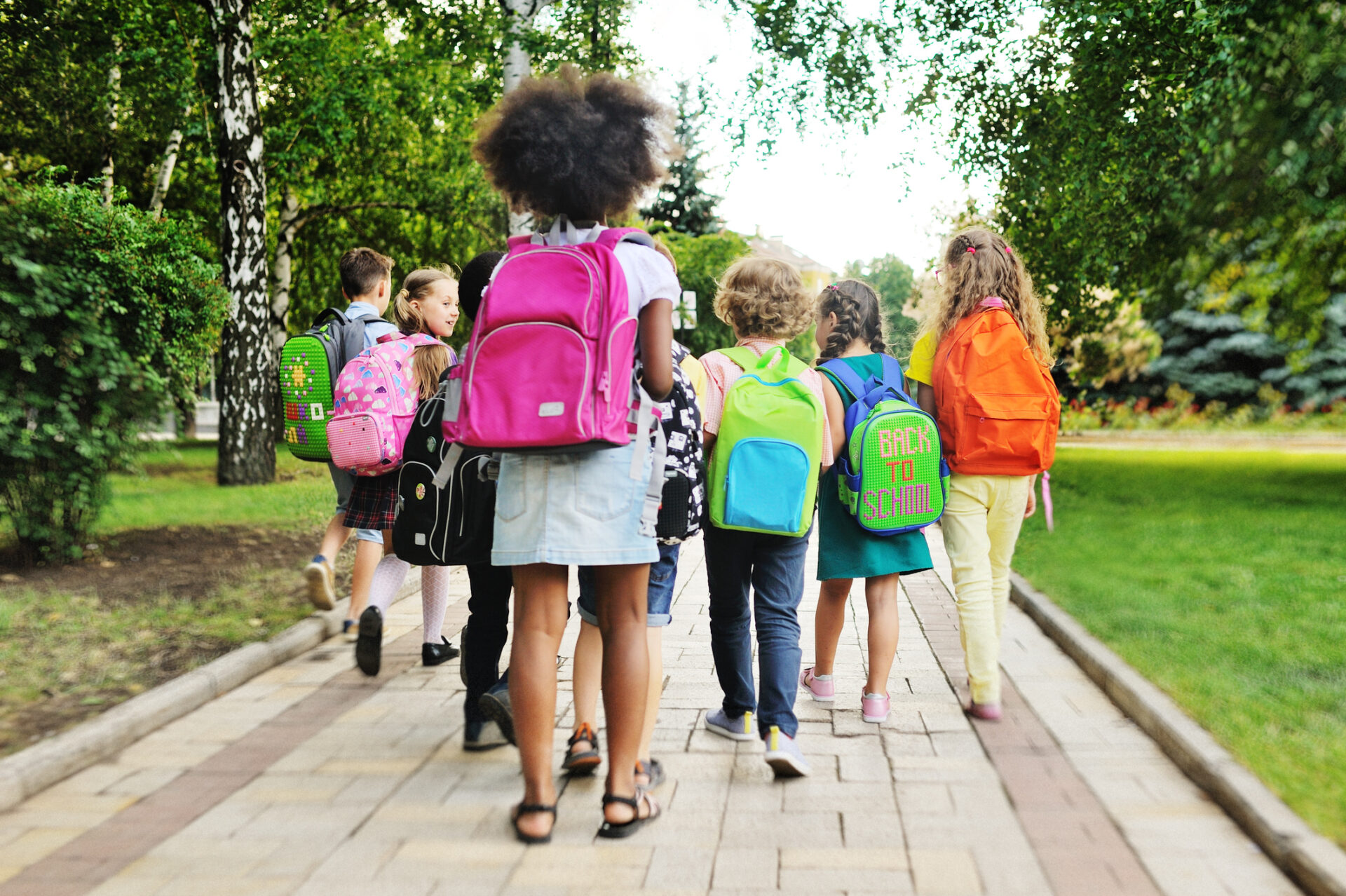 Kids with backpacks headed to school