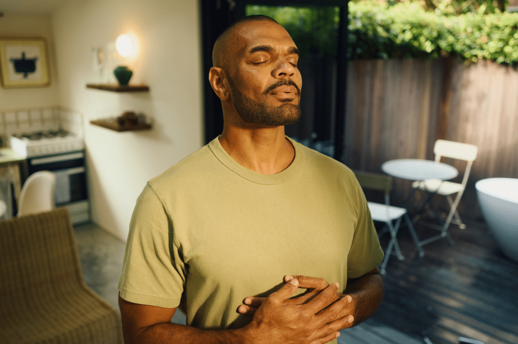 Man meditating at home