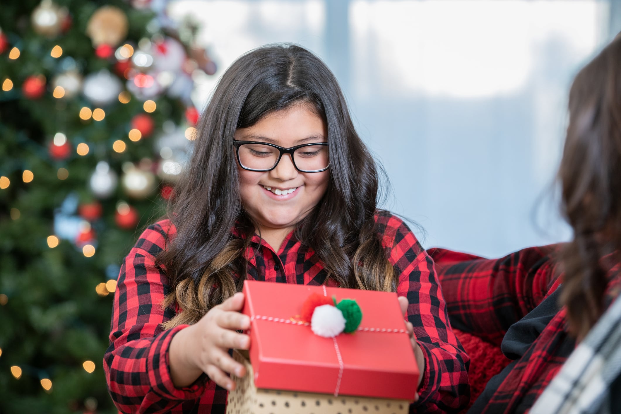 teen holding holiday present teen holding holiday present