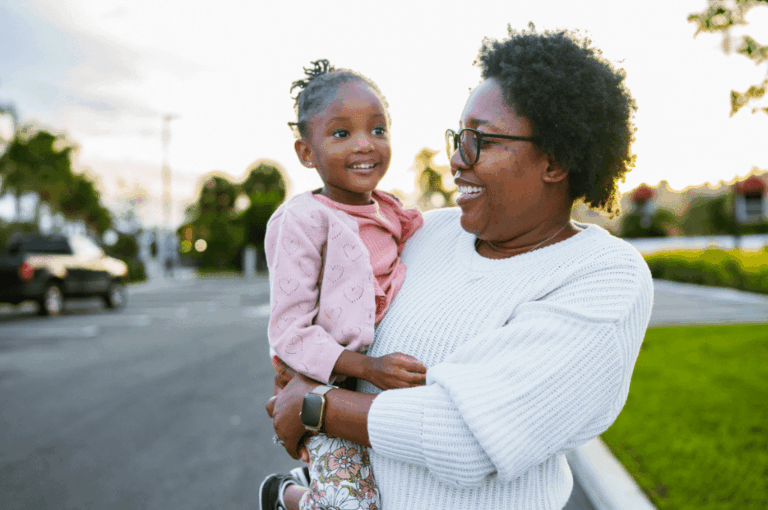 Mother and daughter happy outside