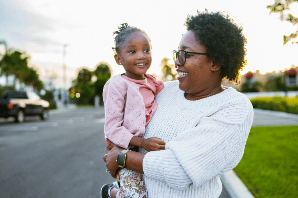 Mother and daughter happy outside