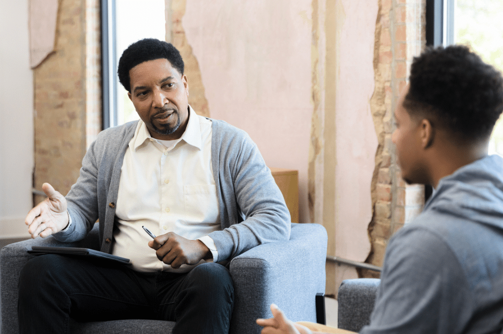 Young man talking to psychiatrist