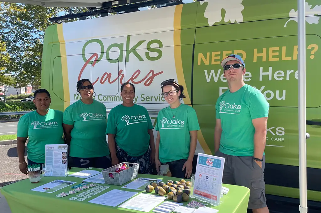 Photo of the Oaks Mobile Van and staff at a display table
