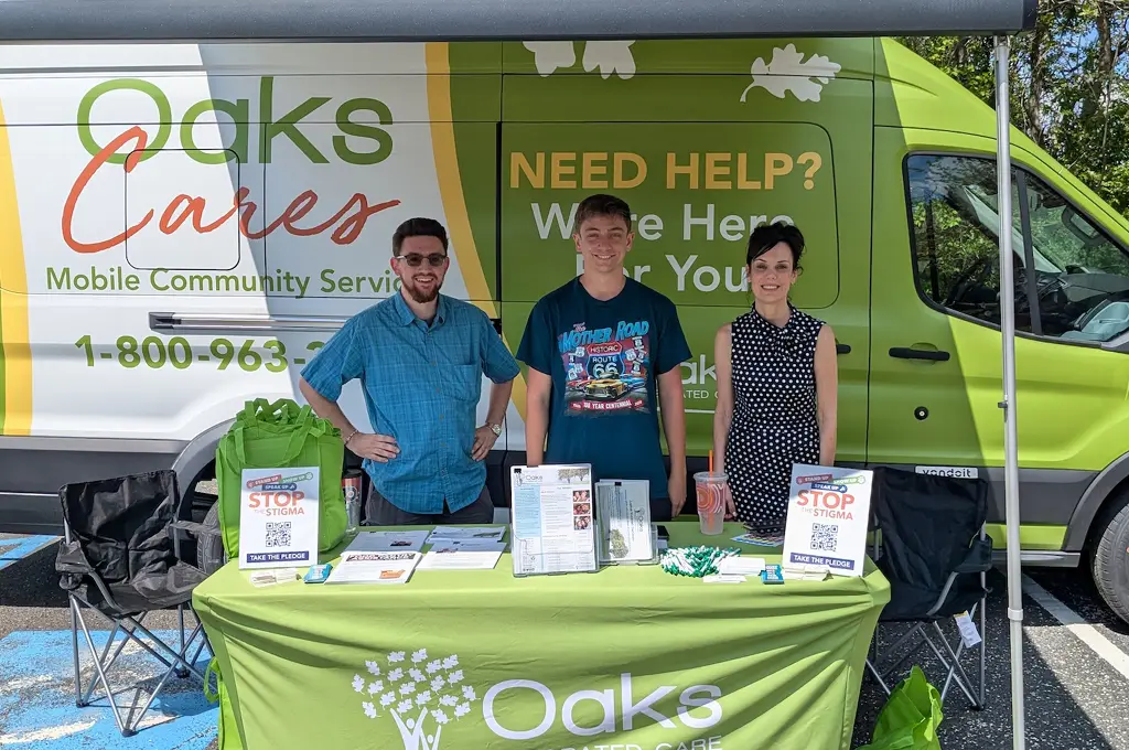 Photo of the Oaks Mobile Van and 3 staff members