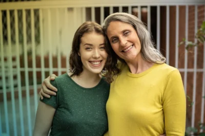 Older Mom and Teen Daughter Smiling